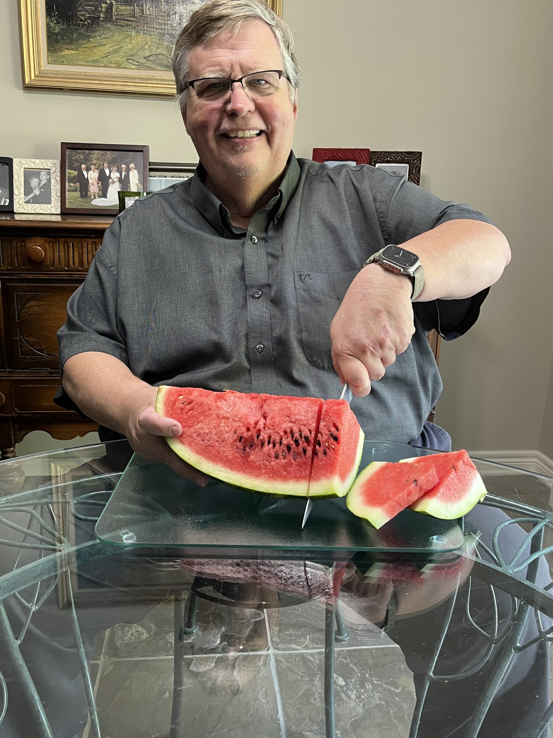 Peter Yurek is slicing watermelon.