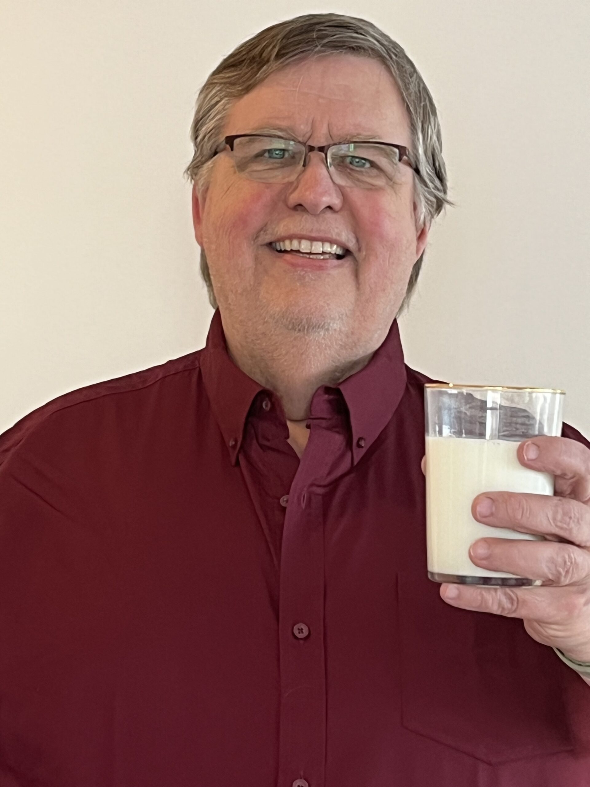 Peter holding a glass of milk