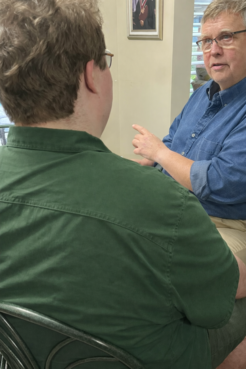 Pete and Matt sitting across from each other and storytelling.