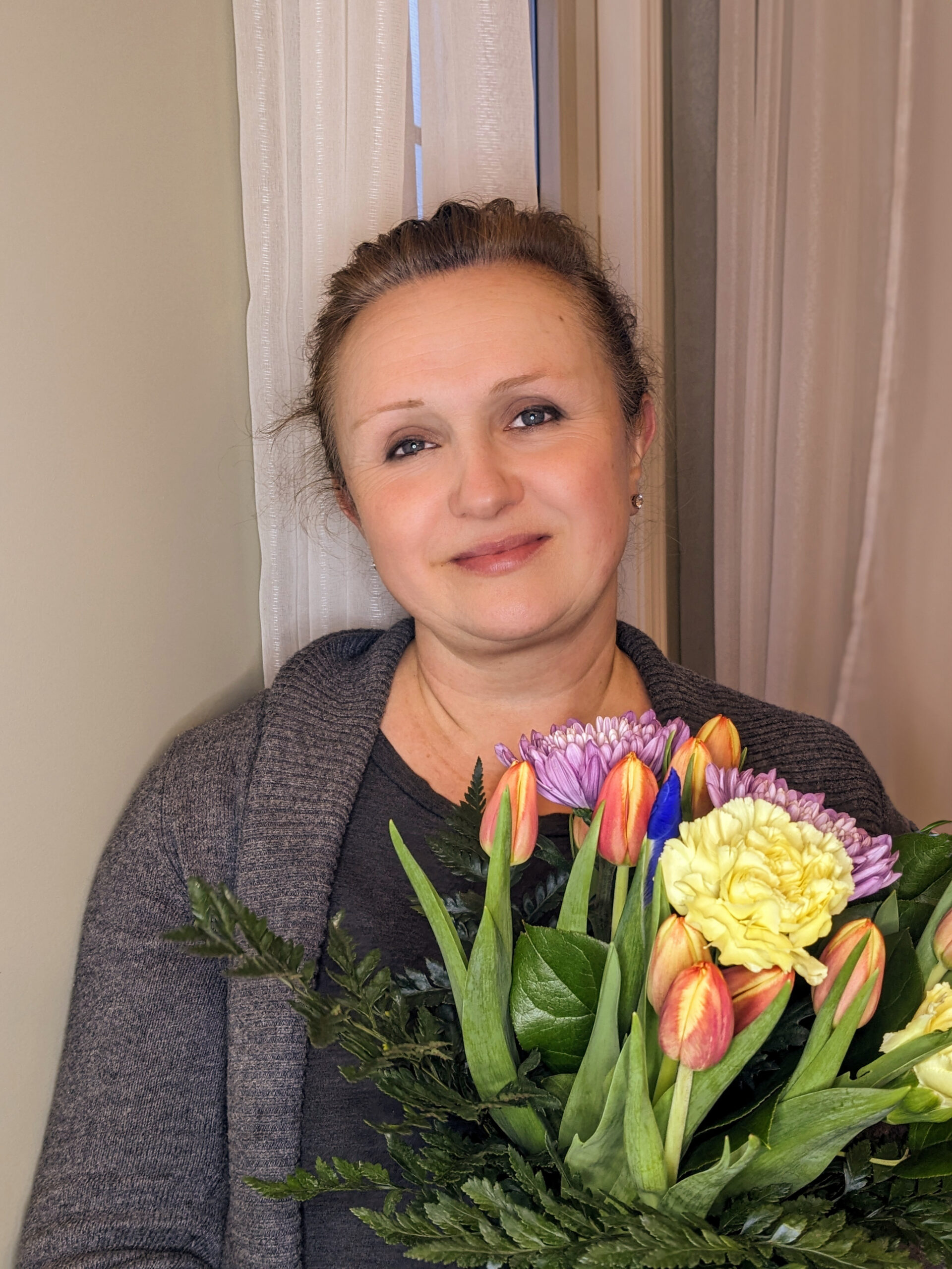 Daria holding a bouquet of flowers.